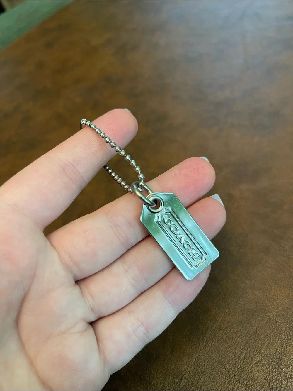 Coach silver metal hangtag